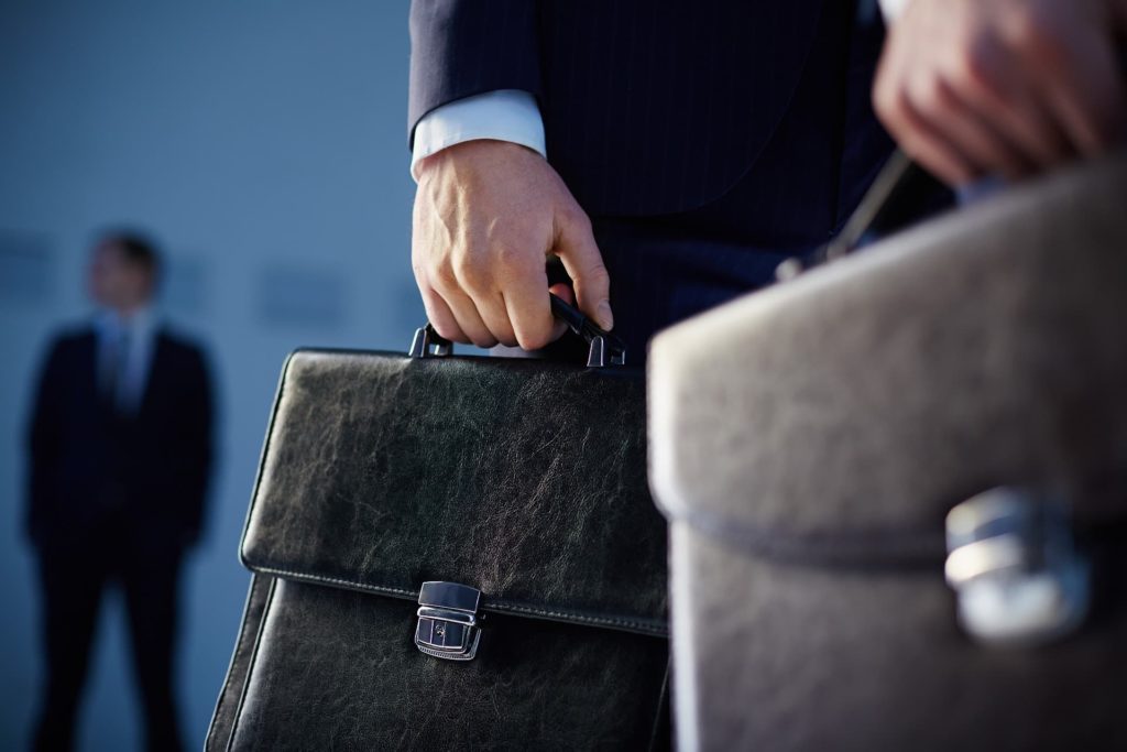 close up of workers with briefcases