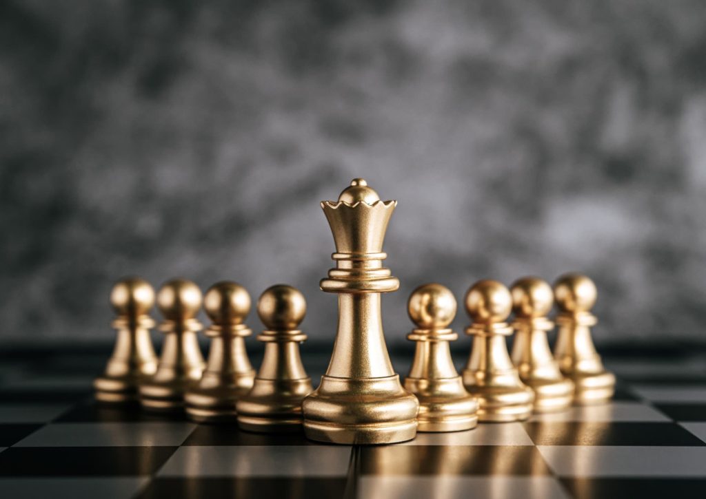 gold chess on chess board game for business metaphor leadership concept